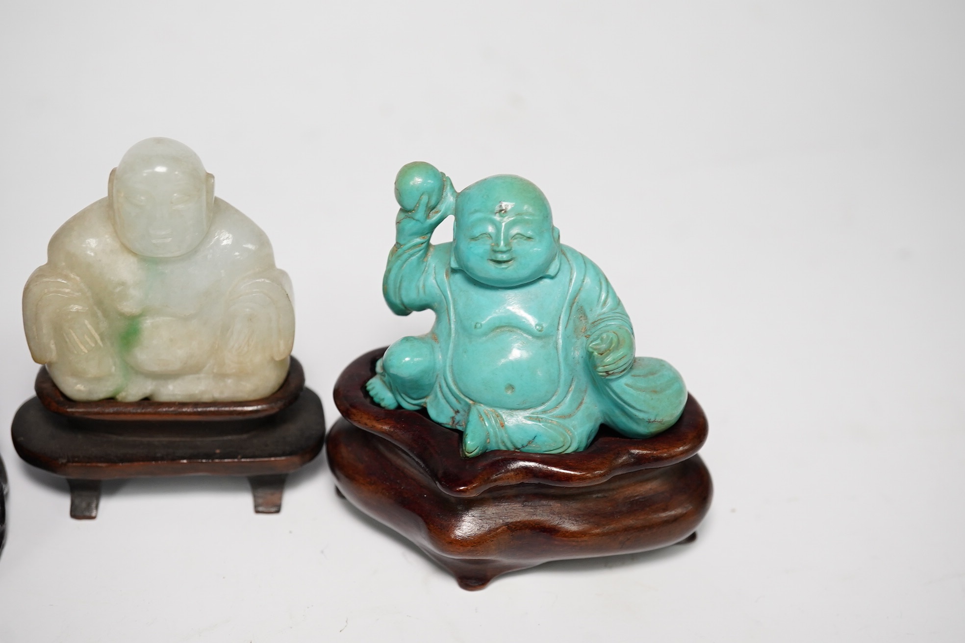 Three Chinese hardstone carvings of Budai, in jadeite, turquoise matrix and amethyst crystal, largest amethyst 4.5cm wide at base (3). Condition - good